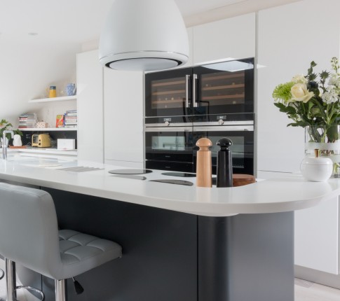 A white and dark blue kitchen island with salt and pepper pots